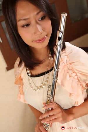 Charming Japanese MILF Yayoi Yanagida posing with a flute in sexy outfit