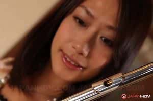 Charming Japanese MILF Yayoi Yanagida posing with a flute in sexy outfit