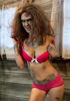 Saucy brunette cosplayer Kleio unveils her zombie tits and pussy