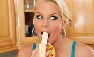 Ravishing mature blonde Marie eats a banana in the kitchen sensually