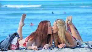 Lesbian girls in bikini kissing tonguing  showing hot ass at the beach