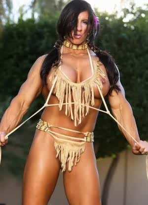 Muscled female Angela Salvagno exposes her big clit in Native American garb