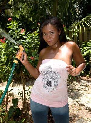 Beautiful ebony coed Candie Lynn oiled  sunning her nice tits in the garden