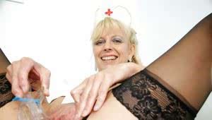 Blonde mature nurse stuffing her cunt with a dildo and a speculum