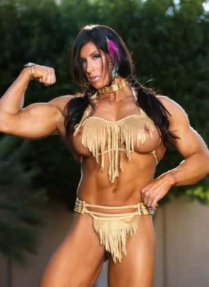 Muscled female Angela Salvagno exposes her big clit in Native American garb