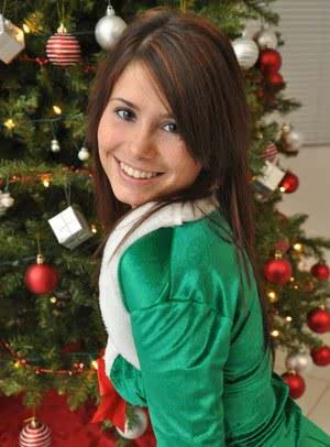 Amateur Xmas elf Hailey lifts her tight skirt to show her sexy ass by the tree