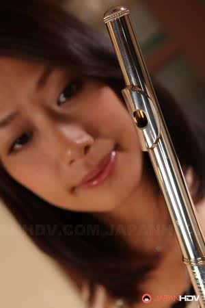 Charming Japanese MILF Yayoi Yanagida posing with a flute in sexy outfit