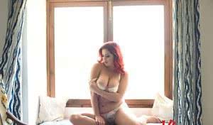 Fat redhead Lucy V unveils her hooters in white underwear