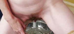 Stocking clad mature woman inserting speculum into hairy vagina