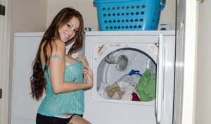 Amateur model Talia Shepard uncovers her knockers while doing laundry