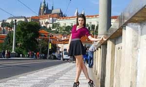 Clothed chick shows off her bare legs in a miniskirt and high heels in public