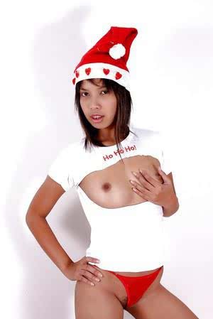 Asian babe with tiny tits is masturbating while wearing a Christmas hat