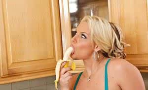 Ravishing mature blonde Marie eats a banana in the kitchen sensually